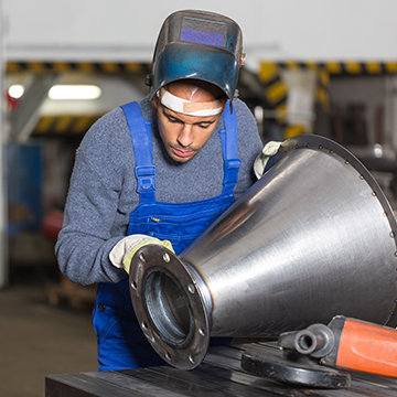 welder inspecting metal piece